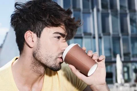 Germany, Cologne, Young man drinking coffee, close up Stock Photos