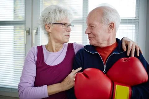 Germany, Duesseldorf, Senior couple with boxing glove, smiling Stock Photos