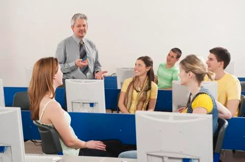 Germany, Emmering, Lecturer explaining students in computer lab Stock Photos