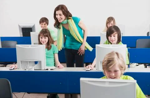 Germany, Emmering, Teacher explaining students in computer lab Stock Photos