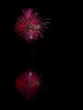Germany, Fireworks exploding in sky at night with reflection 库存照片