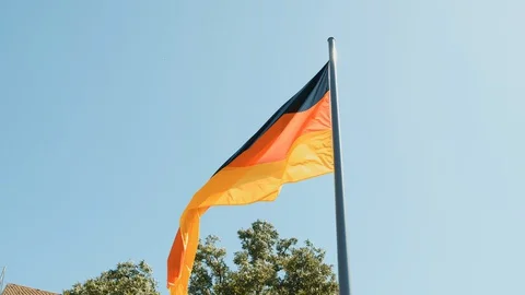 Germany flag on a background of blue sky in the beautiful city of Nuremberg Stock Footage 130143104