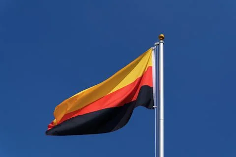Germany flag waving upside down on a flagpole Stock Photos
