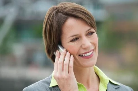 Germany, Hamburg, Close up of business woman on the phone, smiling Stock Photos