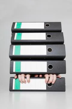 Germany, Human fingers stuck in stack of file 스톡 사진