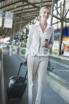Germany, Leipzig-Halle, Airport, Young Woman With Suitcase On Travelator