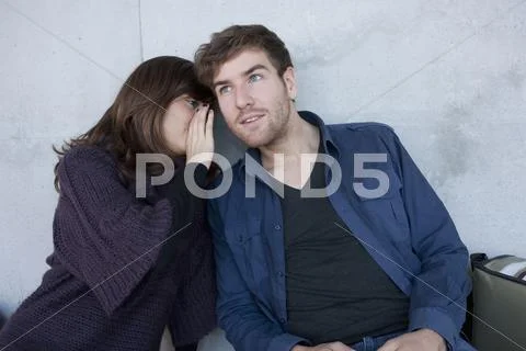 Germany, Leipzig, University students sitting and whispering Stock Photos