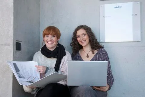 Germany, Leipzig, University students using laptop, smiling, portrait Stock Photos