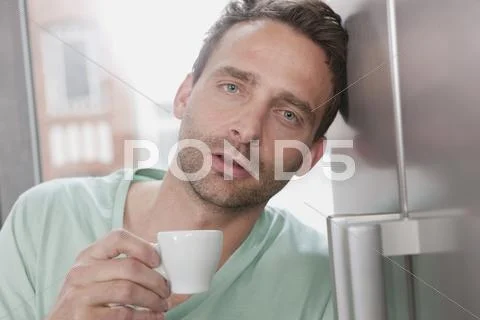 Germany, Man holding cup, portrait Stock Photos