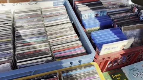 Germany - March 12,2024: looking for CDs and DVDs at the flea fair Stock Footage 267407637