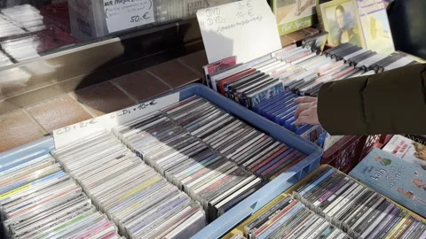 Germany - March 12,2024: looking for CDs and DVDs at the flea fair Stock Footage 267408061
