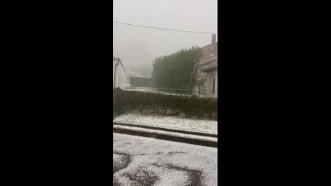 Germany: Massive hail accumulation turns streets white after severe storm... Stock Footage 344039653