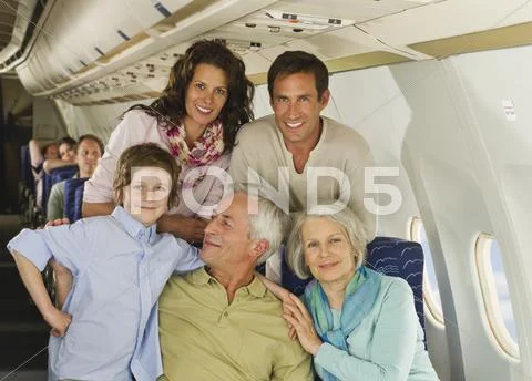 Germany, Munich, Bavaria, Group of passengers in economy class airliner, smiling Stock Photos