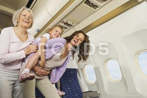 Germany, Munich, Bavaria, Women and girl having fun in economy class airliner Stock Photos