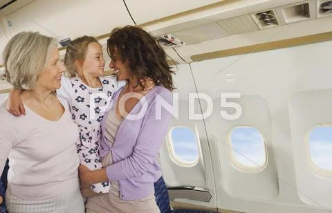 Germany, Munich, Bavaria, Women and girl having fun in economy class airliner Stock Photos