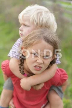 Germany, Munich, Girl annoyed by younger boy Stock Photos