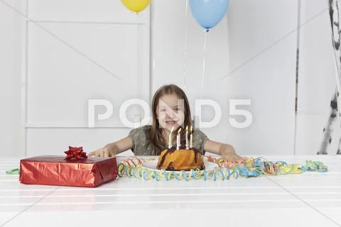 Germany, Munich, Girl With Birthday Cake And Gift, Smiling, Portrait
