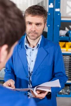 Germany, Neukirch, Apprentice and instructor, instructor holding documents 스톡 사진