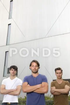 Germany, North Rhine Westphalia, Duesseldorf, Three trainees in front of Stock Photos
