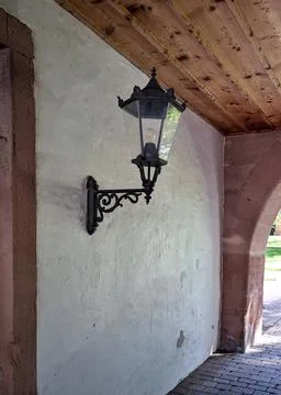 Germany rustic wall lantern beneath wooden arch with stucco and stone detail Stock Photos