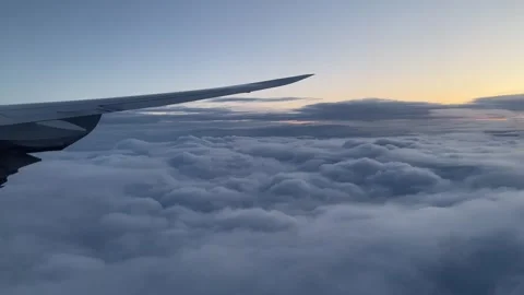 Germany: Sunrise from a plane window above the clouds, 4K Stock Footage 248291143