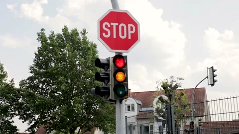Germany Traffic Lights Changing From Red to Green, stop sign on top Stock Footage 131880642