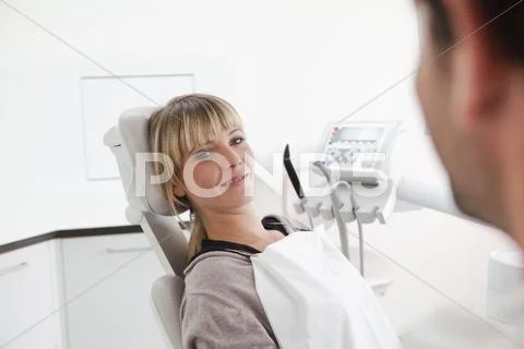 Germany, Young Woman In Dentist Chair, Smiling