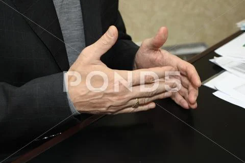 Gesticulating hands of a businessman giving an interview Stock Photos
