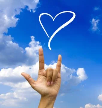 Gesturing hand on blue sky. Stock Photos