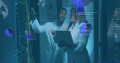 Gesturing IT professionals diagnosing network cables at data center, with laptop Stock Photos