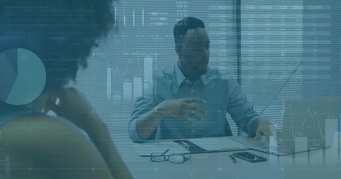 Gesturing man in light shirt presenting chart overlays at meeting table, Stock Photos