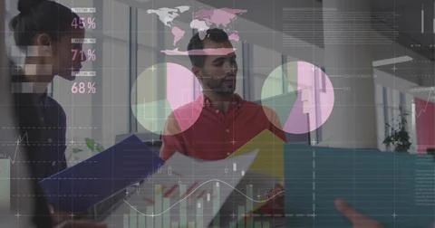 Gesturing red shirt man presenting charts at open office, with colored folders Stock Photos