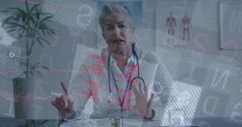 Gesturing senior doctor using holographic display in clinic room, with lab coat Stock Photos
