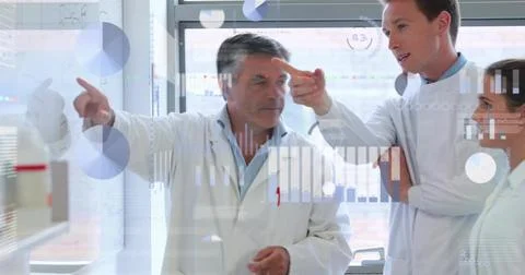 Gesturing senior researcher explaining data on glass board at laboratory window, 库存照片