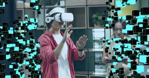 Gesturing in white VR headset interacting with cubes in office lounge, tablet Stock Photos