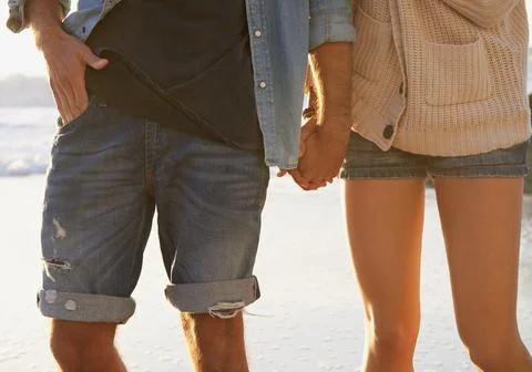 Get away with the one you love. Cropped image of a couple walking hand in hand Stock Photos