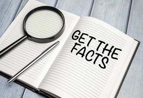 Get the facts word concept on notepad and magnifier Stock Photos