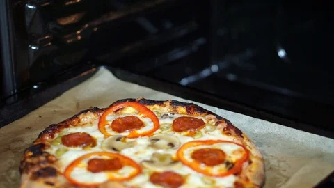 Get the finished pizza out of the oven Stock Footage 105196908