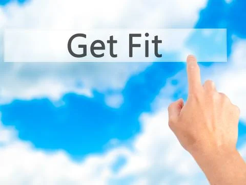 Get Fit - Hand pressing a button on blurred background concept on visual scre Stock-Fotos