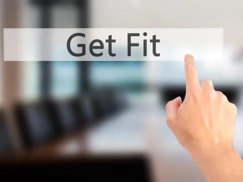 Get Fit - Hand pressing a button on blurred background concept on visual scre Stock Photos