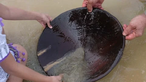 Get the heavy gold particles to settle to the bottom of the pan Stock Footage 172397851