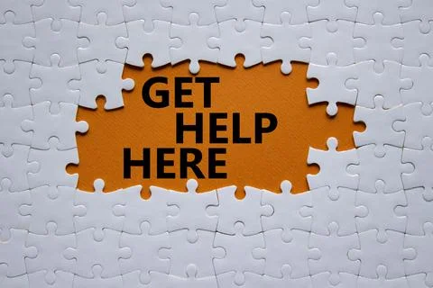 Get help here symbol. White puzzle with words Get help here. Beautiful oran.. Stock Photos