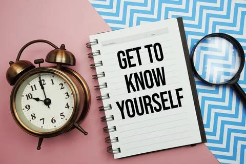 Get To Know Yourself text written on notepad with alarm clock and magnifyin.. Stock Photos