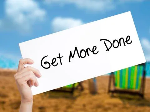 Get More Done Sign on white paper. Man Hand Holding Paper with text. Isolated Stock Photos