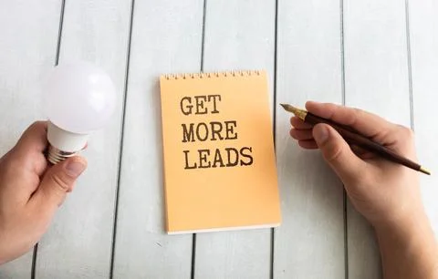 Get More Leads text as memo on notebook with tablet and phone. Stock Photos
