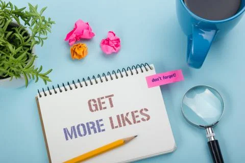 Get More Likes concept. Notebook page with text, red pencil and coffee cup Stock Photos