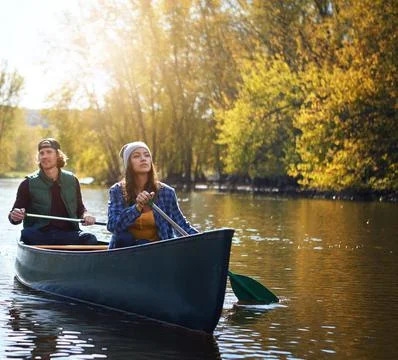 Get out and explore more. a young couple going for a canoe ride on the lake. Fotos de archivo