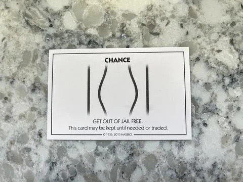 A get out of Jail Free card from a monopoly set. Stock Photos