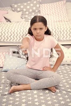 Get out of my room. Girl child sit on bed in her bedroom. Kid unhappy someone Stock Photos