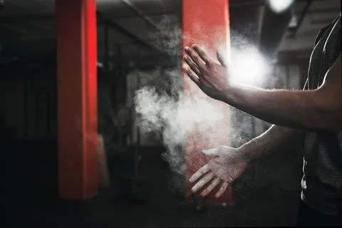 Get ready to get active. an unrecognizable man dusting his hands with talcum Stock Photos